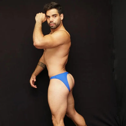 Blue bikini jockstrap underwear by Arroyman featuring a minimal design and a snug fit modeled by a man against a dark background.