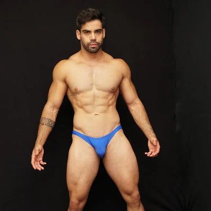 Blue bikini jockstrap underwear by Arroyman featuring a snug fit and minimal coverage modeled by a man.