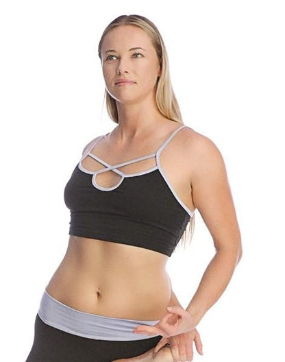 Black bra top with silver crisscross straps and light gray trim designed for sports and active wear
