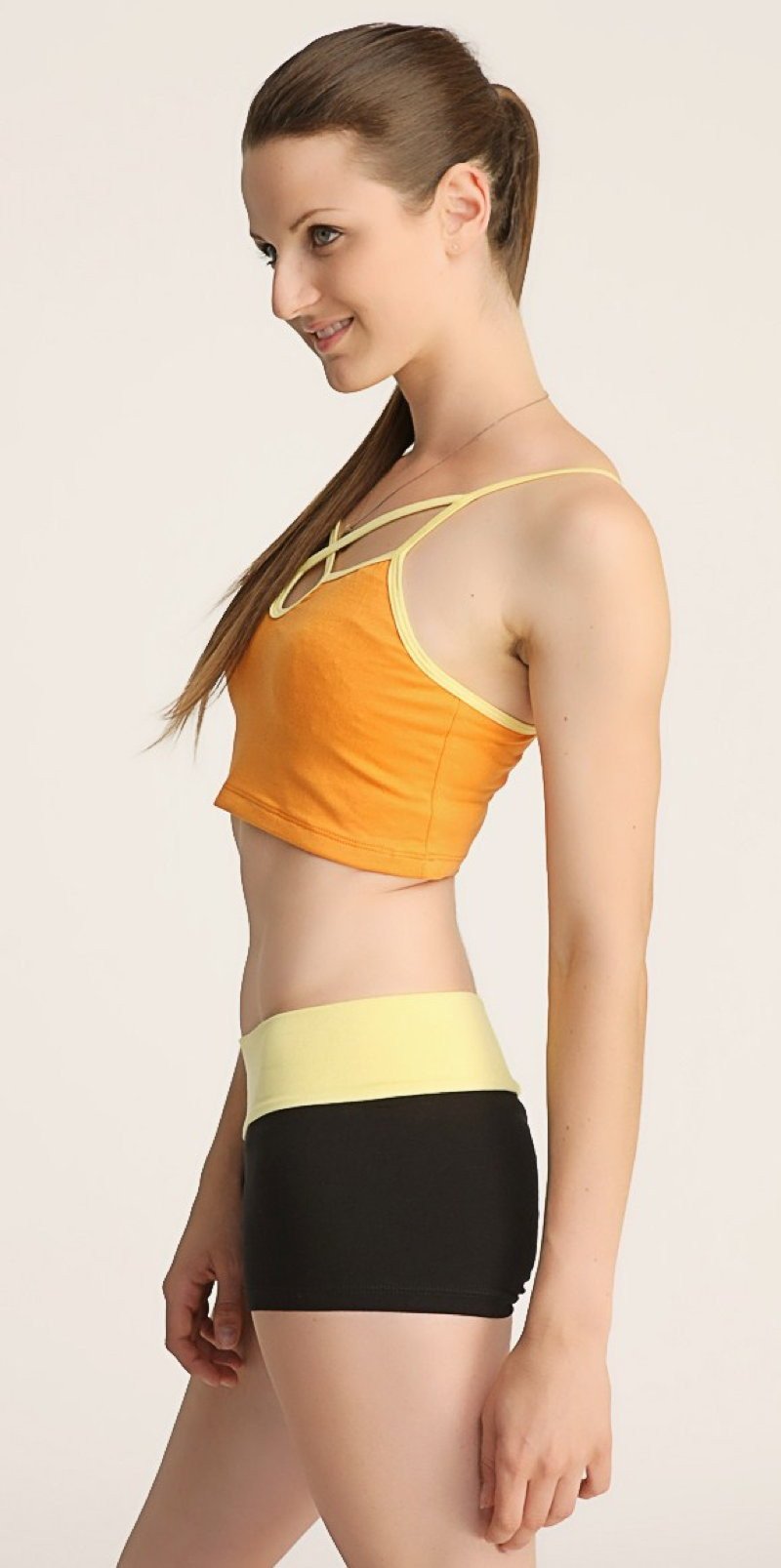 Orange and yellow cropped top with thin straps and matching high-waisted black shorts bumble short set