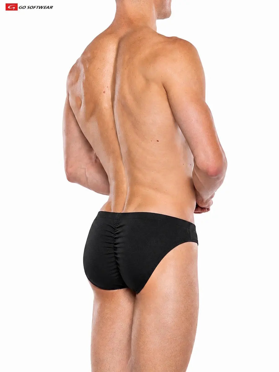 Model wearing Go Softwear black contour brief showcasing a fitted design and gathered back detail viewed from the side