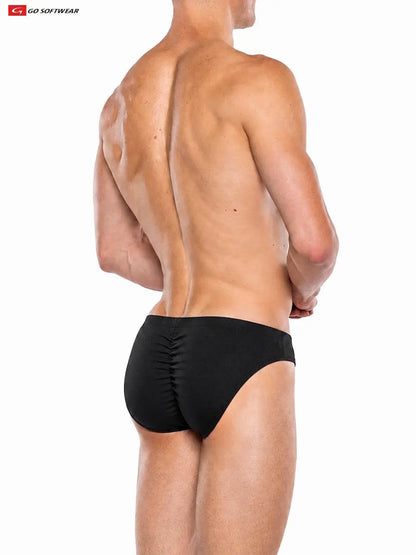 Model wearing Go Softwear black contour brief showcasing a fitted design and gathered back detail viewed from the side