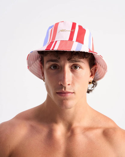 Cabana bucket hat with red white and light blue stripes and a gold embroidered logo on the front