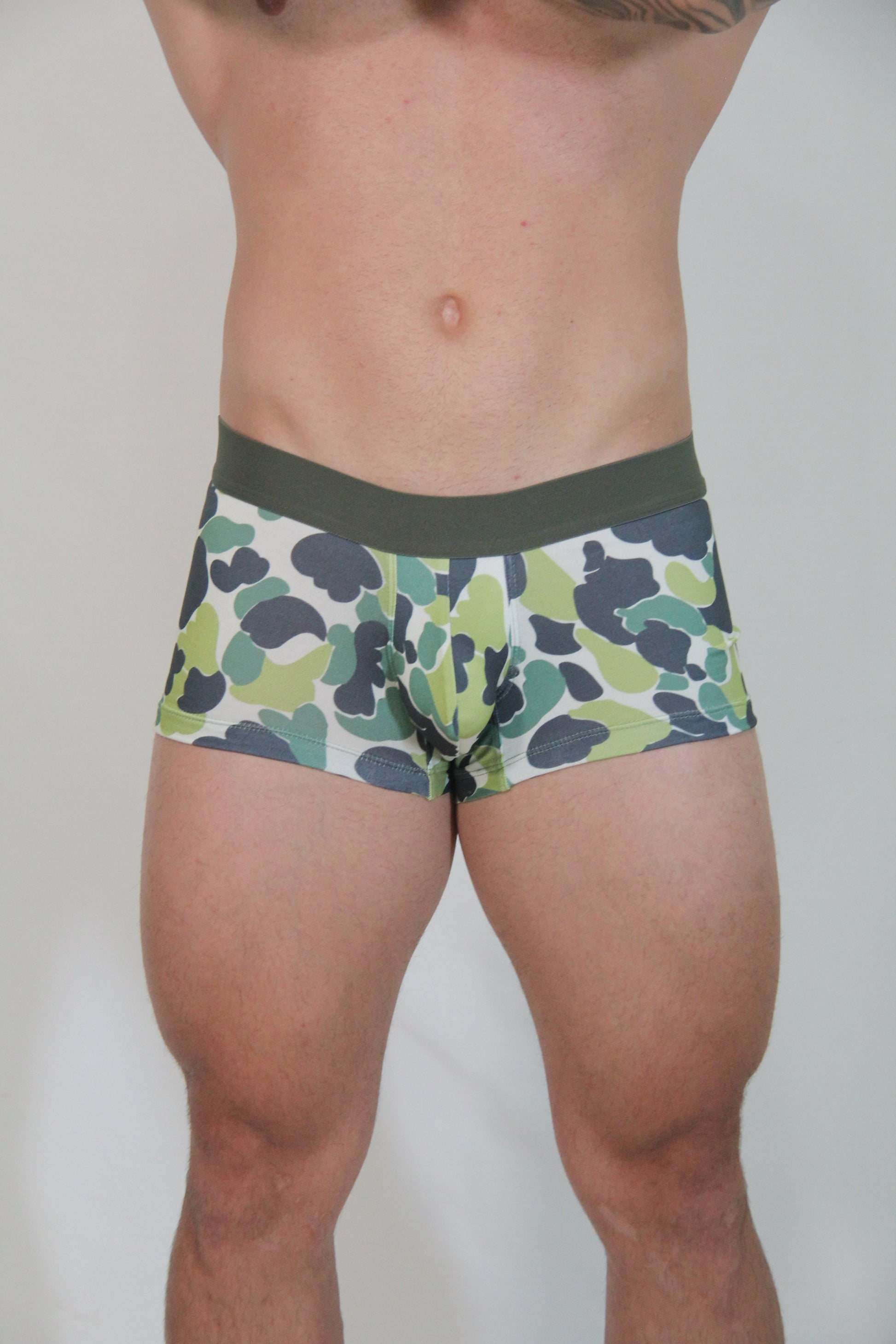 Green and black camouflage trunk briefs with solid olive green waistband designed for comfortable everyday wear