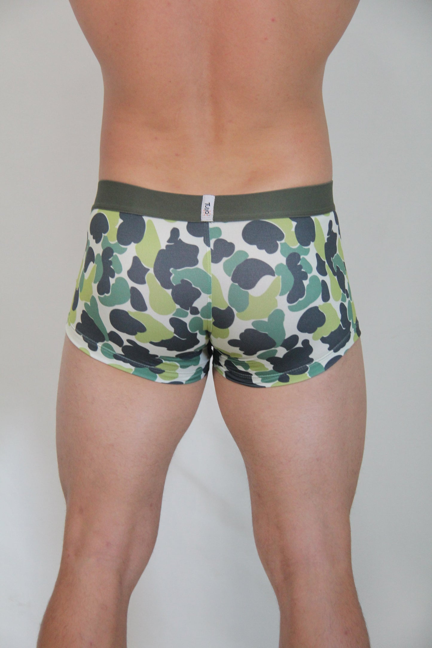Green and black camouflage patterned men’s briefs with olive green waistband featured in camouflage trunk product