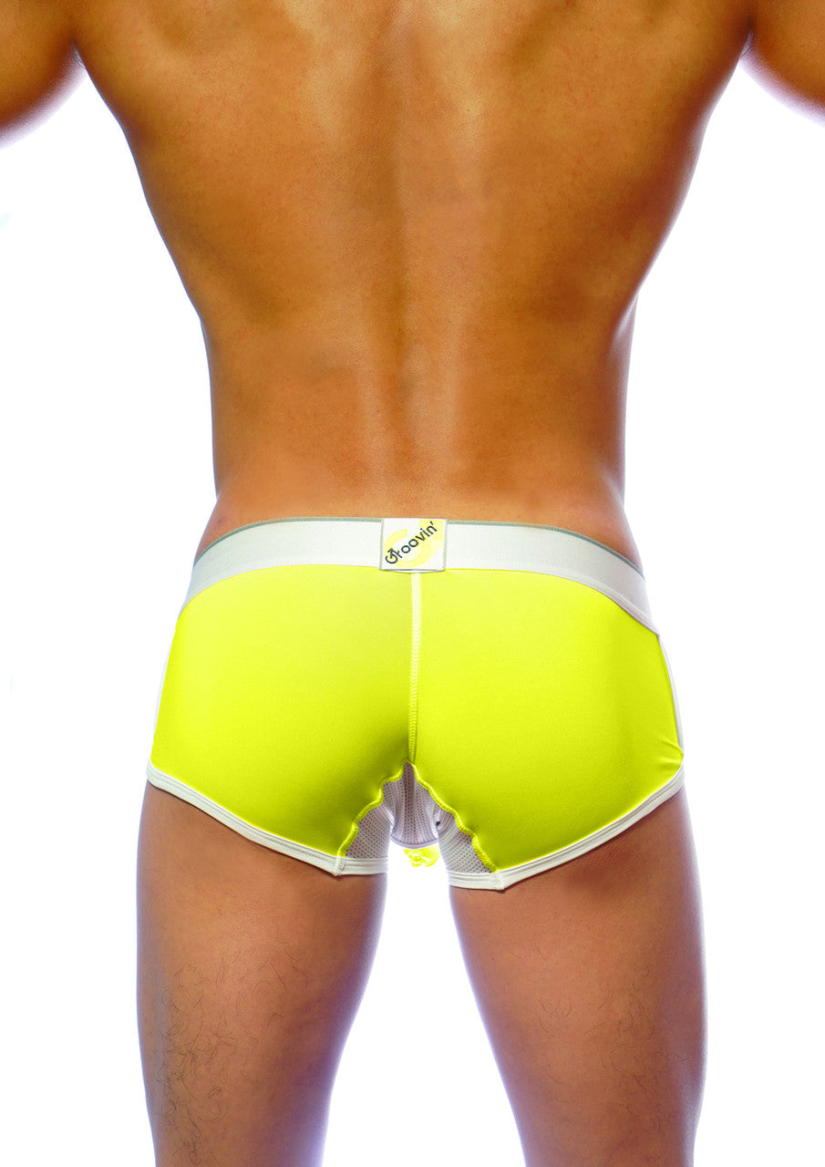 Bright neon yellow groovin underwear ventilated cup boxer with white trim mesh back panel and brand tag visible from back