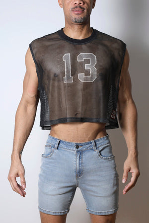 Black mesh crop top with the number 13 on the chest, paired with light blue denim shorts.