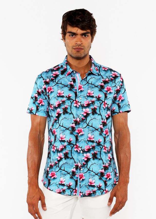 A vibrant turquoise short-sleeved stretch knit shirt with 3d cherry blossoms print and dark branch pattern