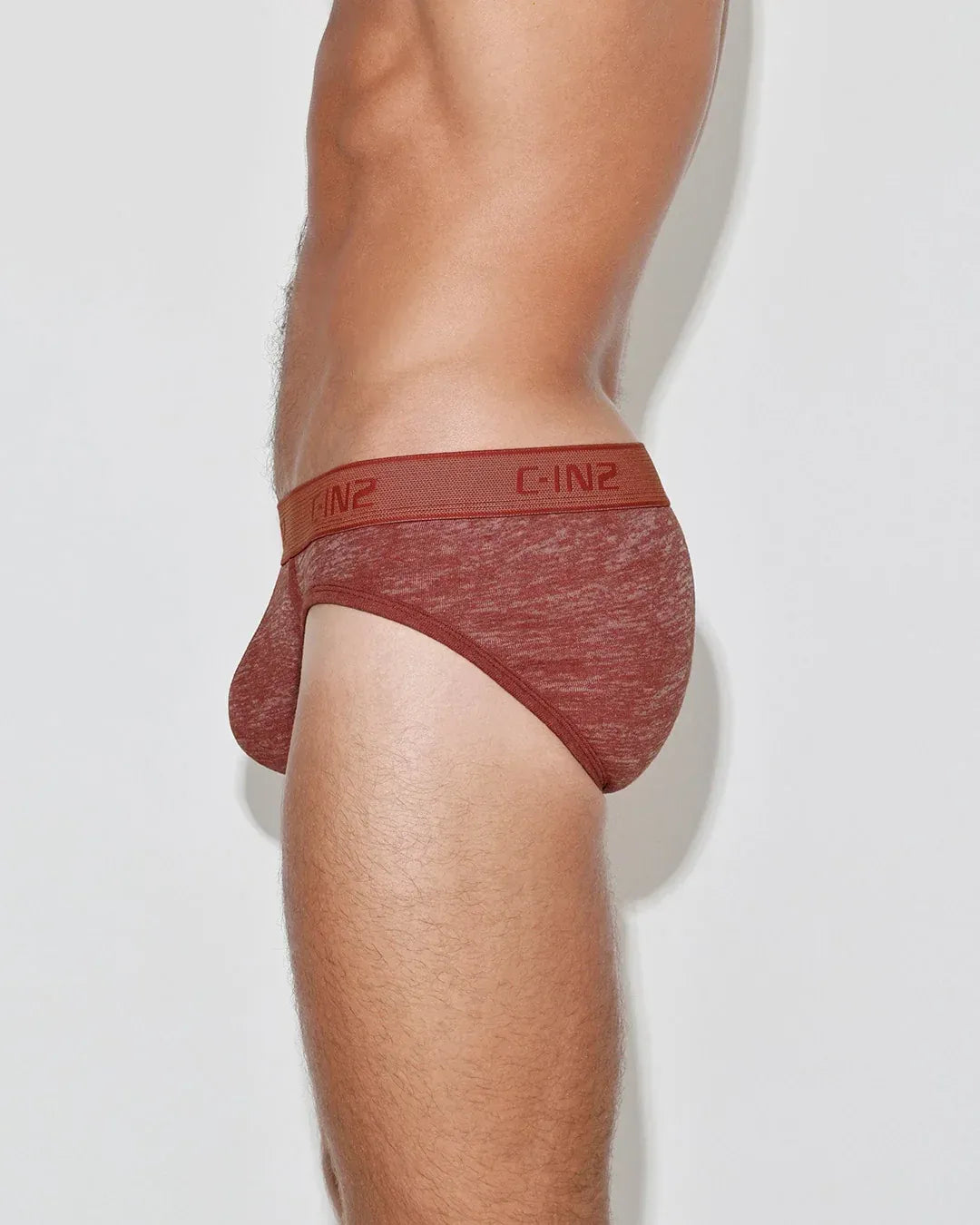 Low rise brief in a rich rust color with a soft texture featuring a C-IN2 logo waistband shown on a model from the side