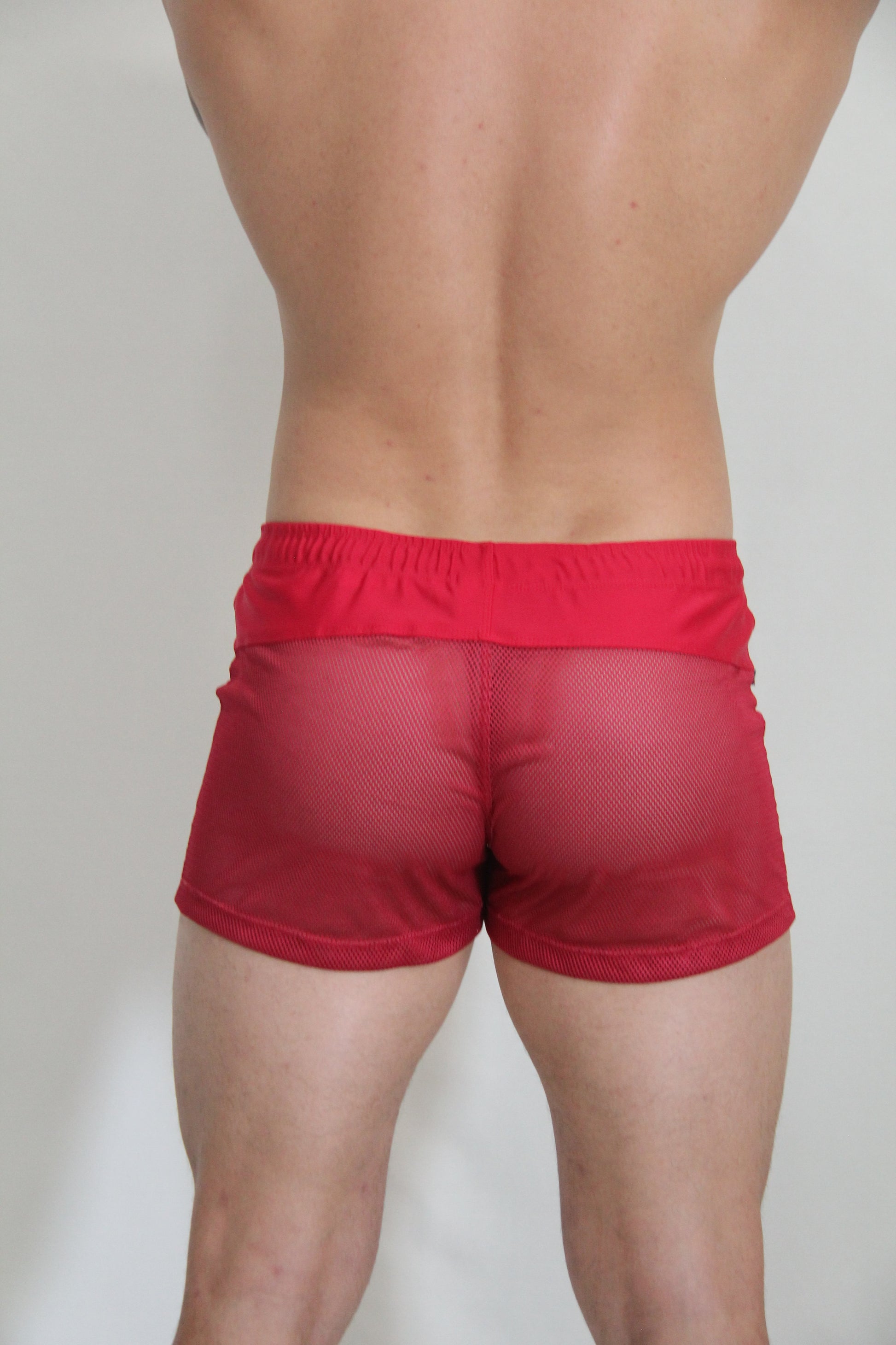 Red mesh shorts with a solid red elastic waistband from circuit mesh short available in 4 colors