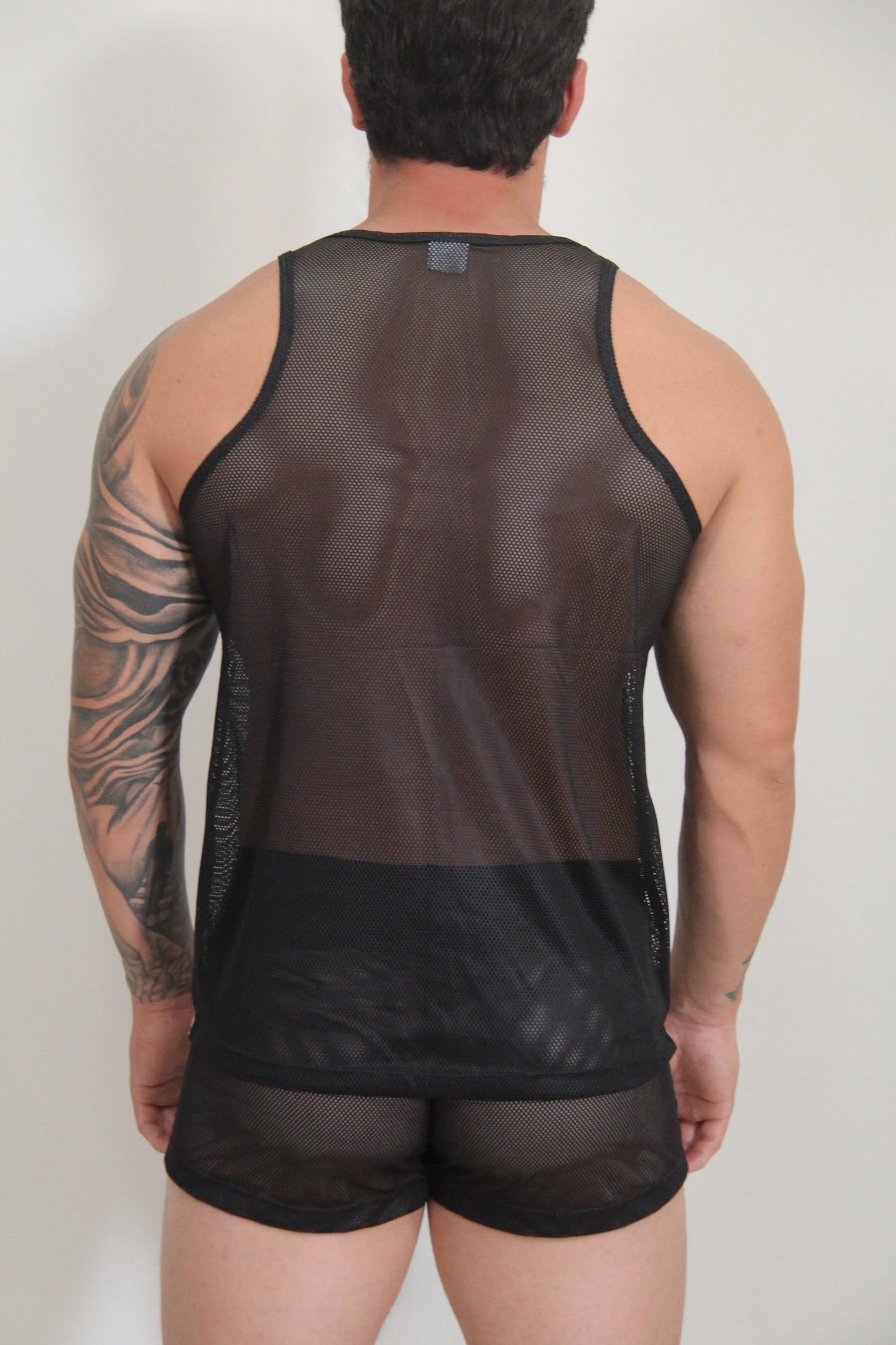 Black mesh tank top with solid black band at the bottom from circuit mesh tanks available in 4 colors