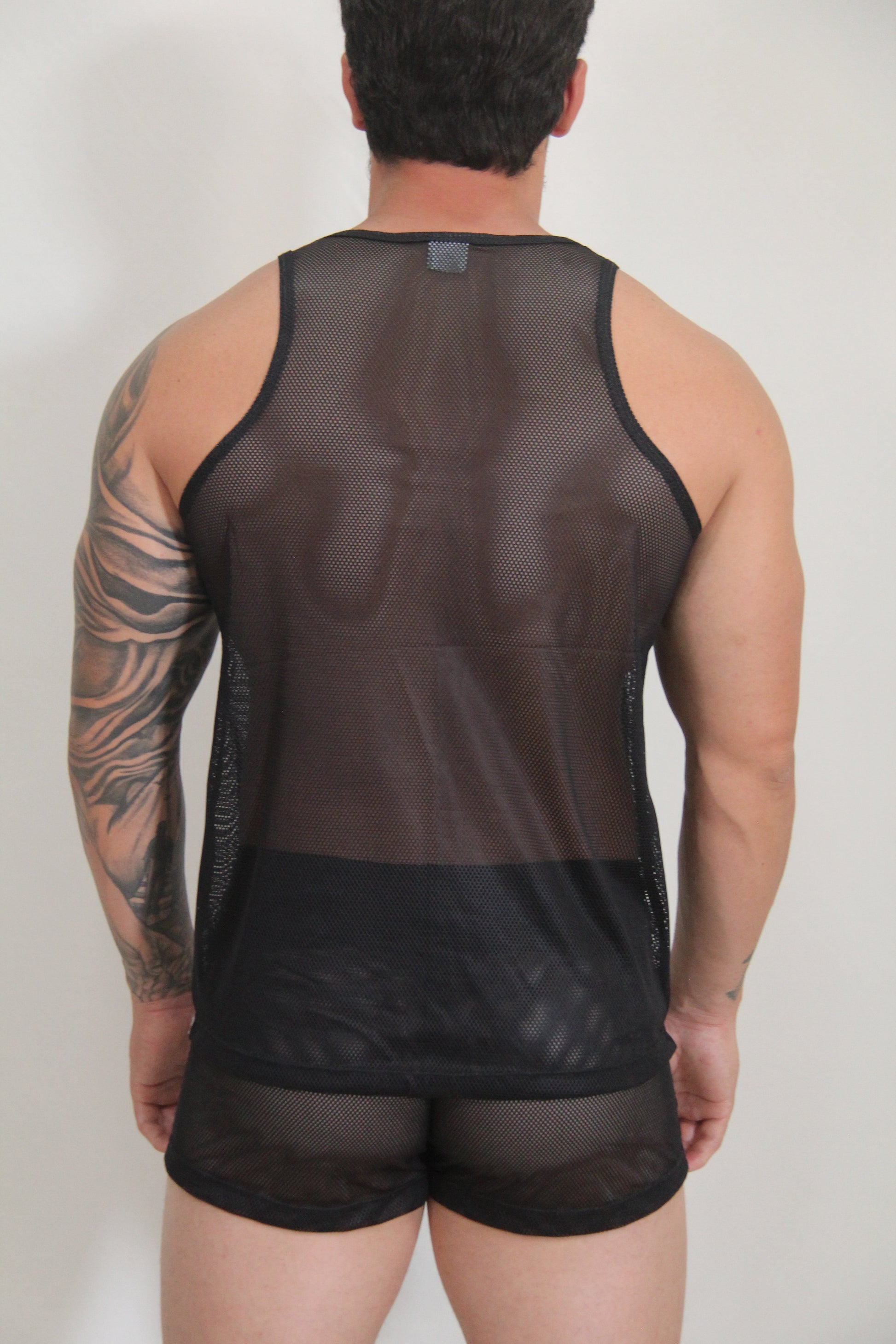 Black mesh tank top with solid black band at the bottom from circuit mesh tanks available in 4 colors