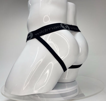 White WildmanT jockstrap on a mannequin featuring a black branded elastic waistband and thin leg straps.
