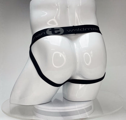 White WildmanT Big Boy jockstrap on a mannequin, featuring a black waistband with the brand name and logo.