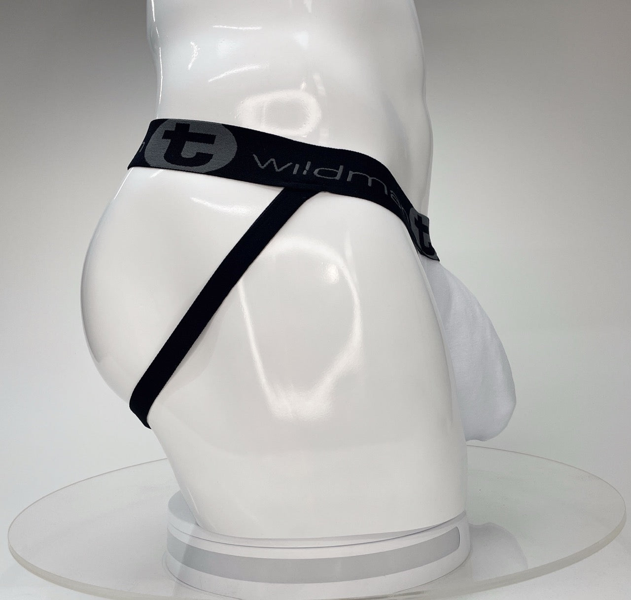White WildmanT Big Boy Pouch jockstrap on a white mannequin, featuring a black waistband with branded logo.