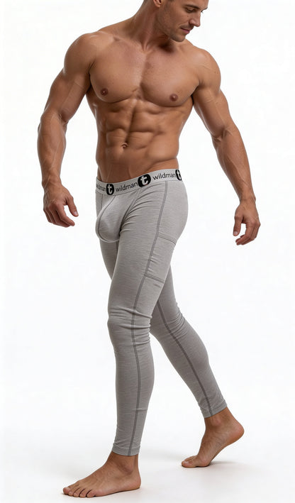 Muscular man wearing heather gray WildmanT Big Boy pouch long johns with a branded black-and-white elastic waistband.