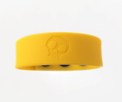 Bright yellow silicone cock strap wristband with subtle embossed skull design for edgy fashion accessory