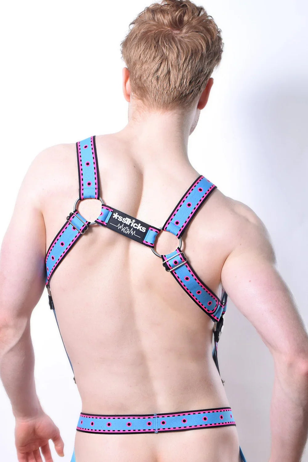 Blue polka-dotted leather comicaze harness with black metal rings and branded label visible on the front side
