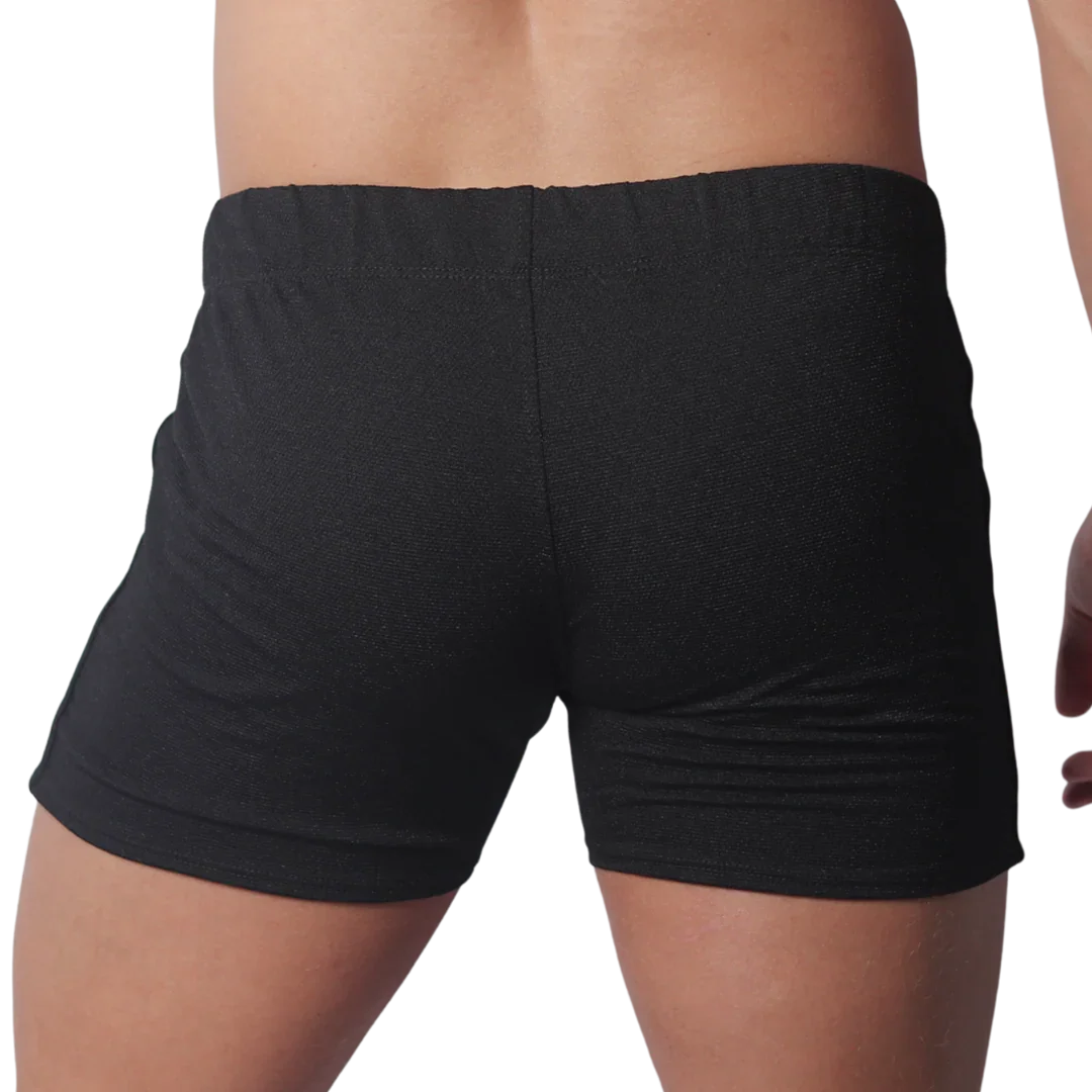 Back view of black form-fitting athletic shorts with a textured fabric and elastic waistband.