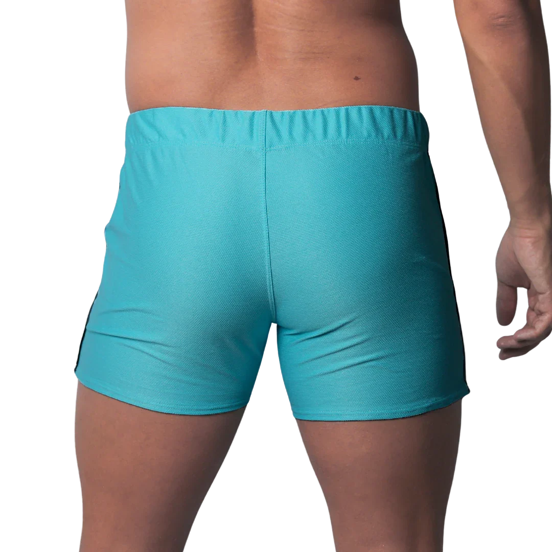 Back view of turquoise blue fitted athletic shorts with a textured honeycomb fabric and an elastic waistband.