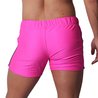 Fuchsia athletic short-shorts in a textured performance fabric with an elastic waistband, viewed from the back.