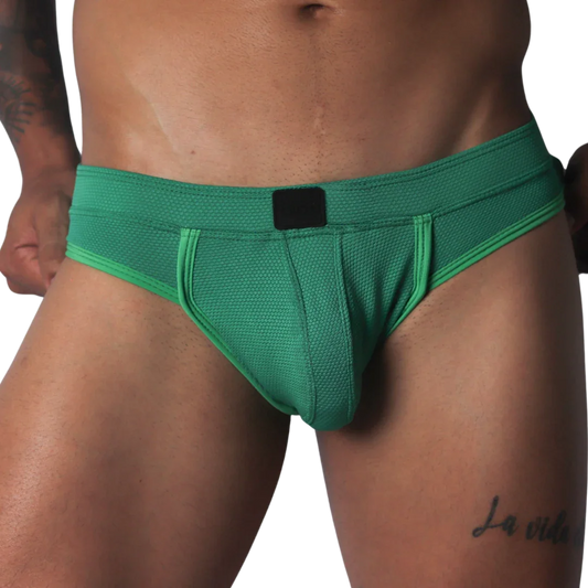 Green jockstrap featuring a textured honeycomb fabric, wide waistband, and a solid black central logo patch.