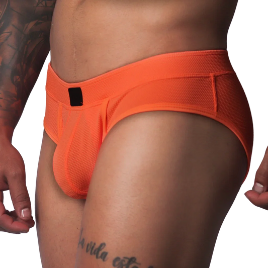 Bright orange textured mesh athletic brief with a wide waistband and a small black rectangular logo patch in front.