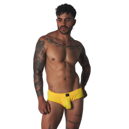 Bright yellow mesh low-rise brief with a centered rectangular black logo patch.