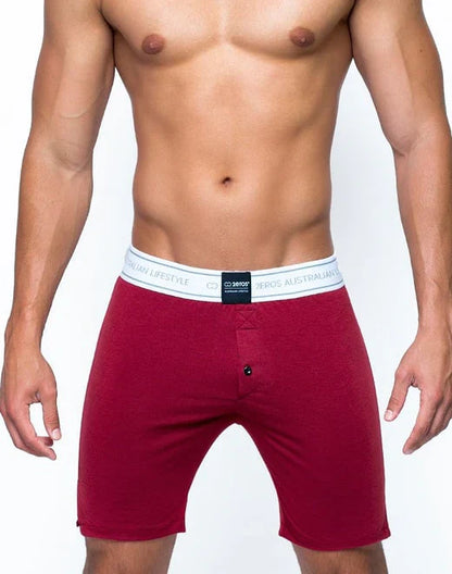 Red men’s boxer shorts from core series lounge short with white elastic waistband featuring black branding text