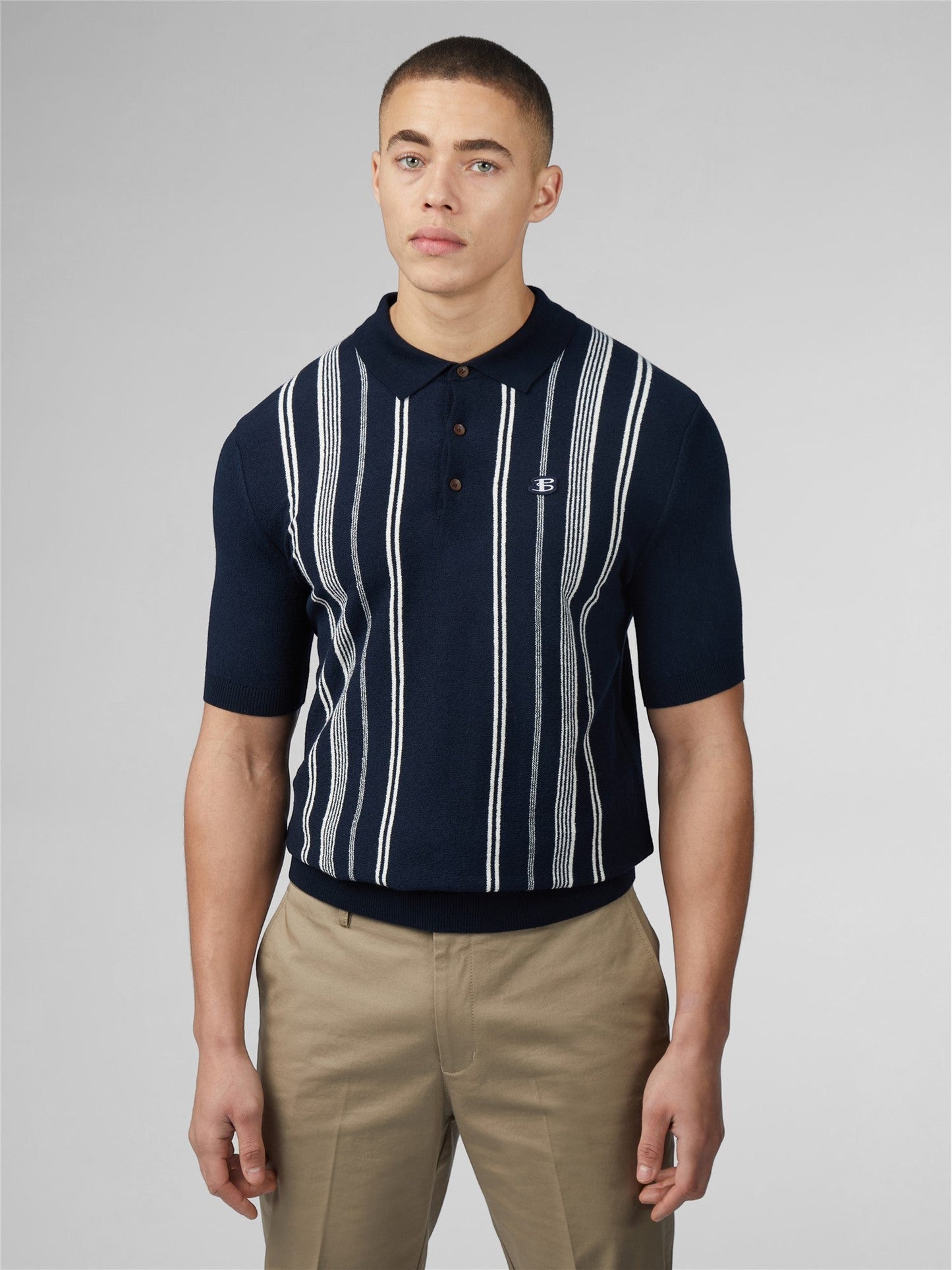 Navy blue crinkle cotton short-sleeved polo shirt with white vertical stripes and small chest embroidered logo