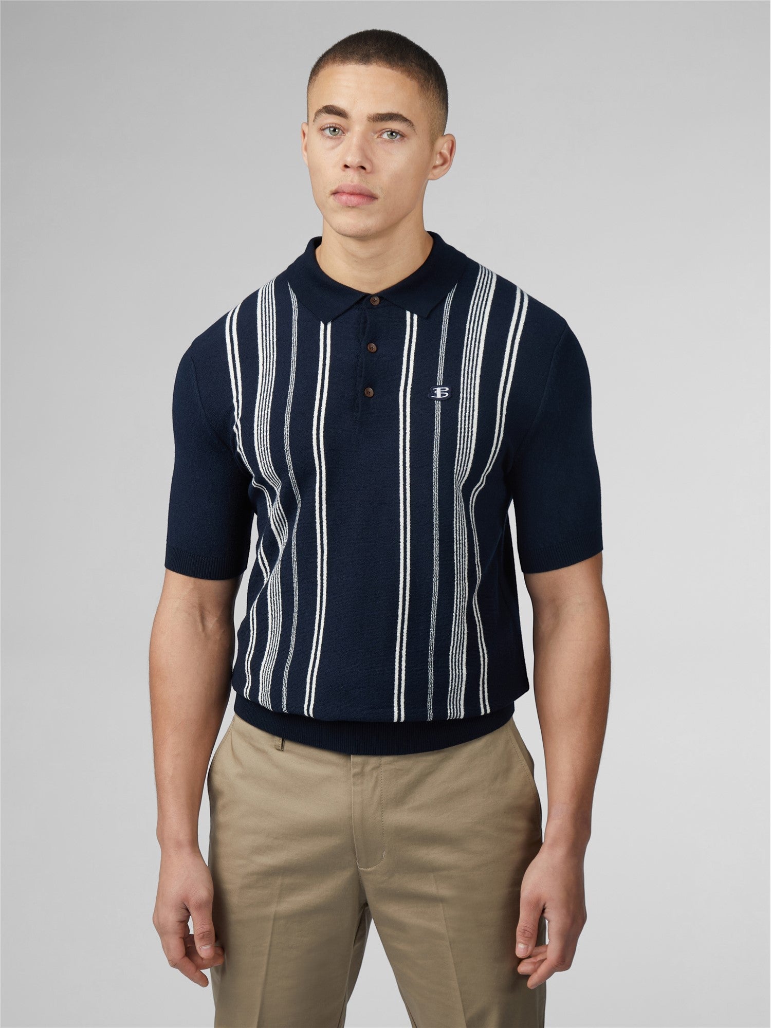 Navy blue crinkle cotton short-sleeved polo shirt with white vertical stripes and small chest embroidered logo