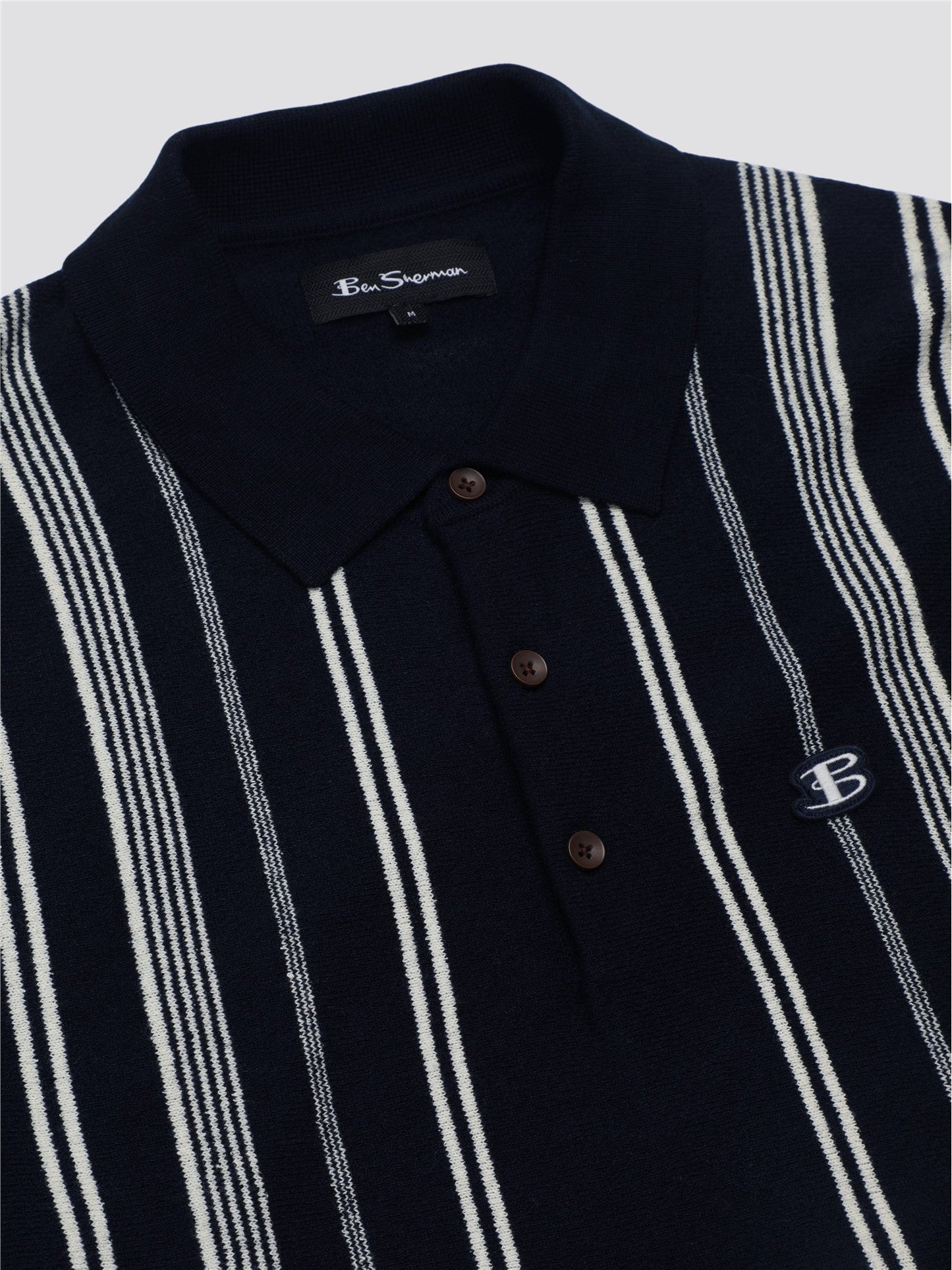 Navy blue and white striped crinkle cotton polo shirt with a small embroidered logo on the chest