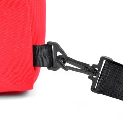 Red crossbody canvas sling bag with black webbing strap and plastic buckle for hands-free carrying