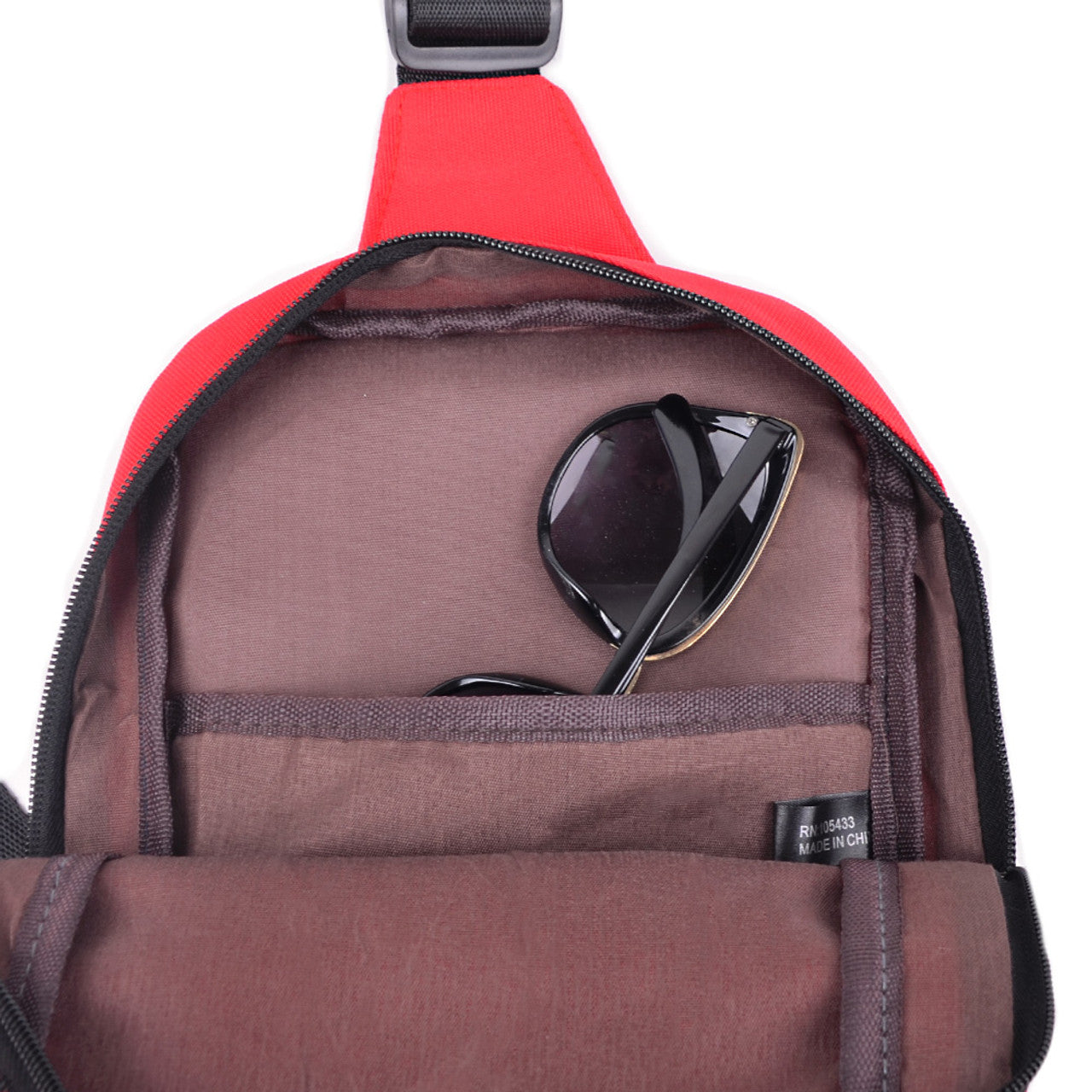 Red nylon crossbody canvas sling bag with black zipper and adjustable strap for hands-free carrying
