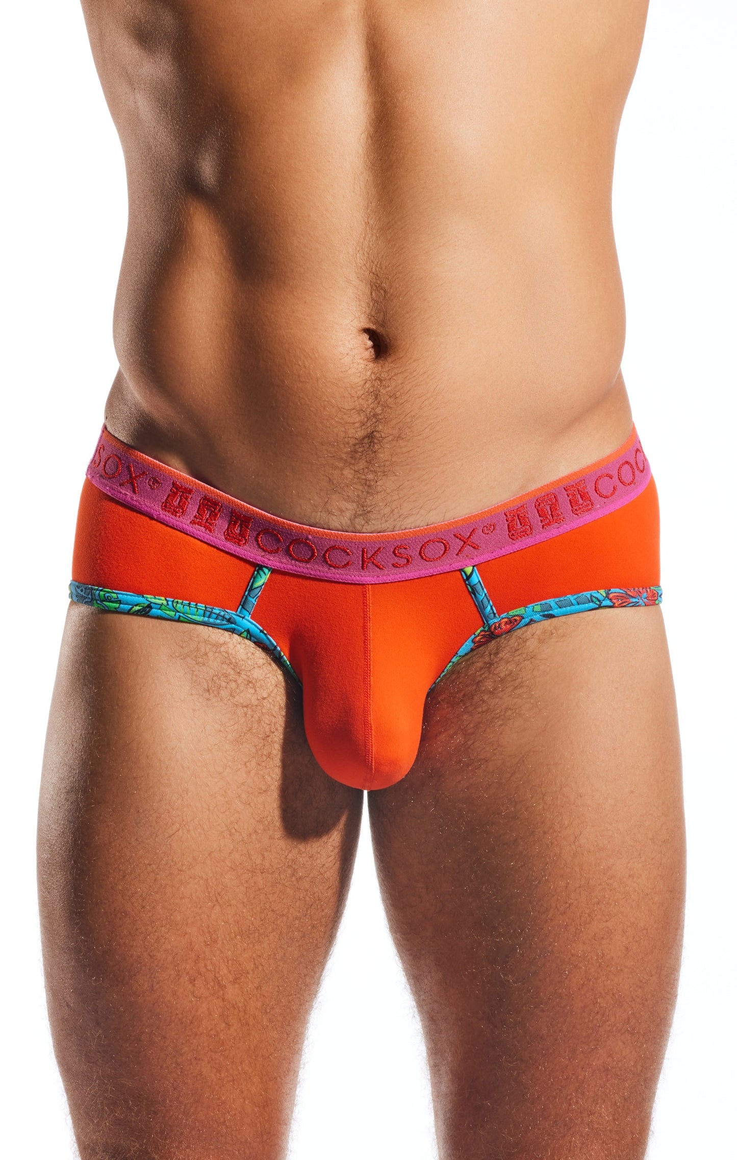 Bright orange Cocksox CX76N supplex sports brief with pink logo waistband and blue patterned trim for men