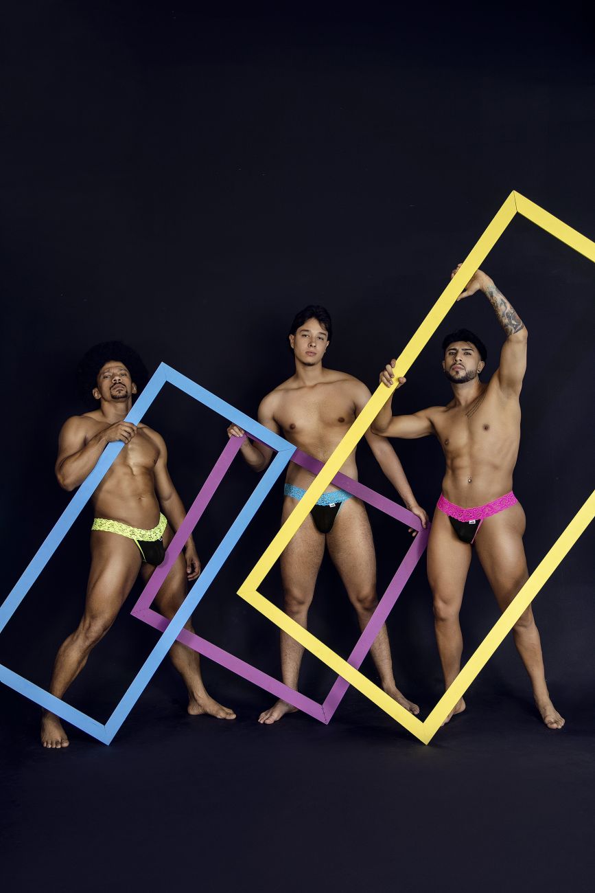 Three men pose with colorful oversized blue purple and yellow frames in front of a dark background for Candyman 99370 lace thongs color blue product
