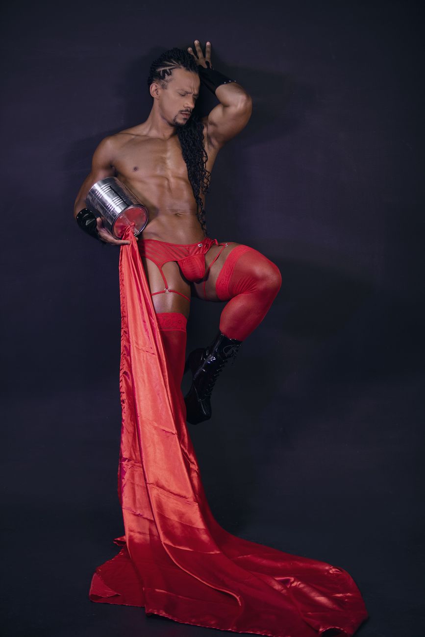 Shiny red satin fabric flowing from a mans leg showcasing candyman 99792 mesh garter thongs in red