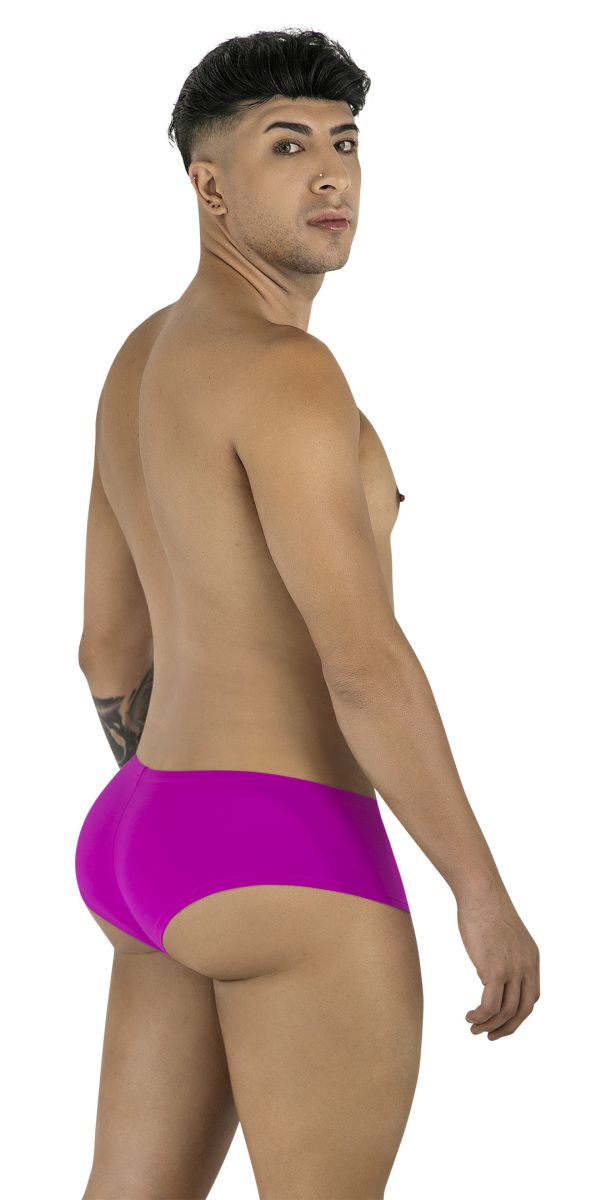 Model wearing CandyMan 99943 magenta trunks. Low-rise, form-fitting style with smooth fabric and a partial back cut.