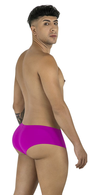 Model wearing CandyMan 99943 magenta trunks. Low-rise, form-fitting style with smooth fabric and a partial back cut.