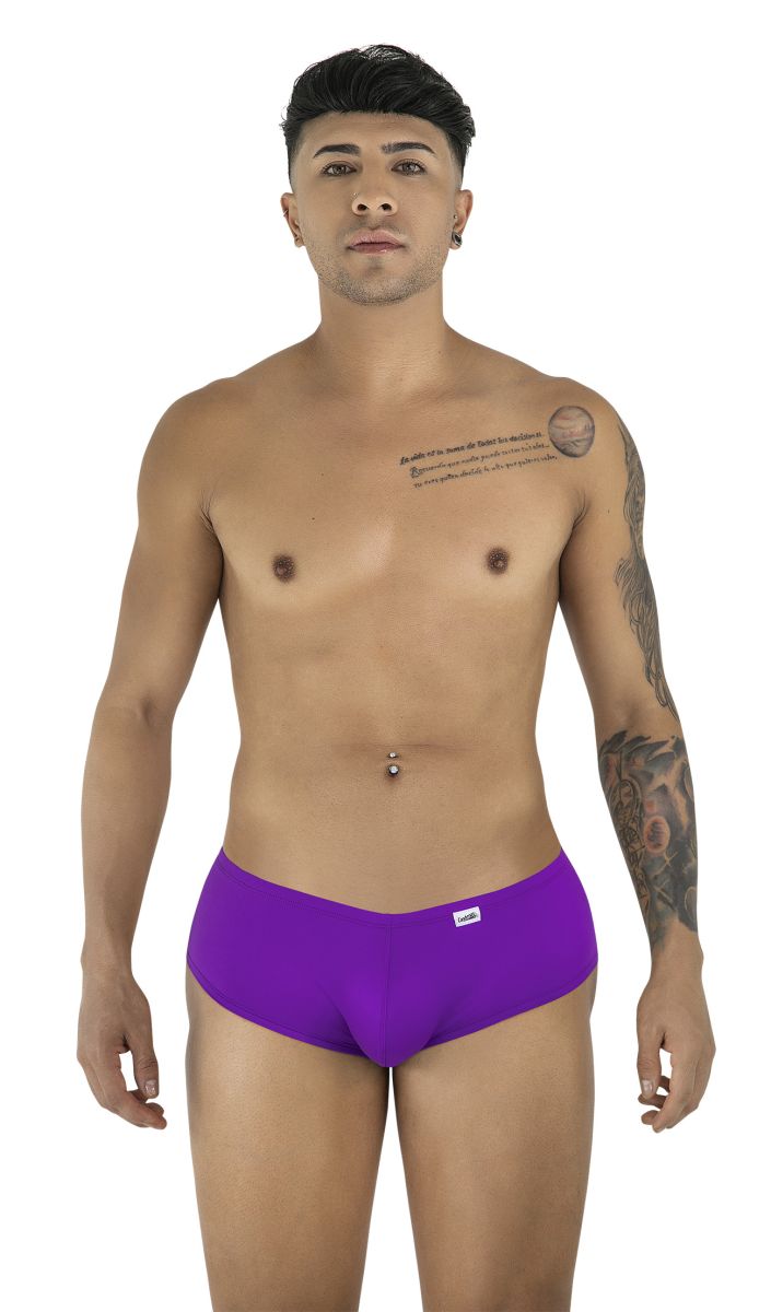A man wears CandyMan 99943 orchid-colored trunks with a low-rise, form-fitting cut and a small logo tag.
