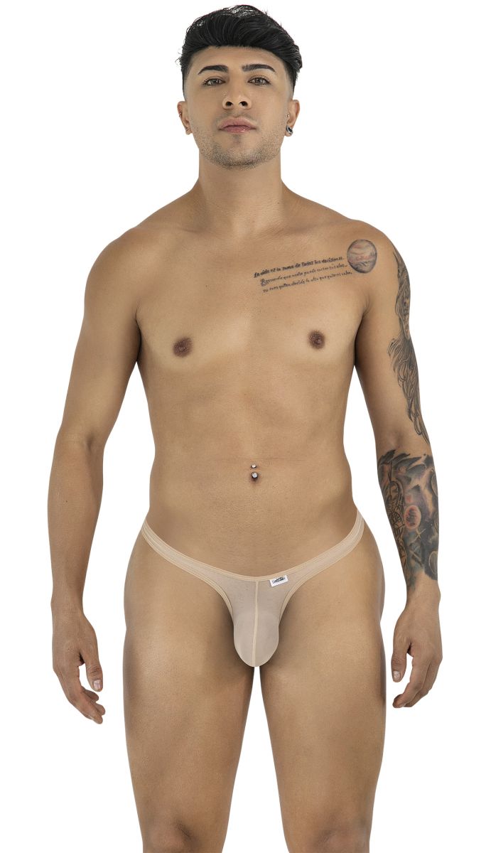 Model wearing a beige mesh CandyMan thong with a minimal cut, featuring a thin waistband and small brand label.