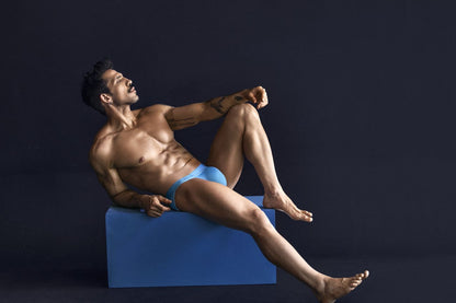 A man wearing bright blue clever 1749 eco bikini briefs showing the front side in sustainable fabric