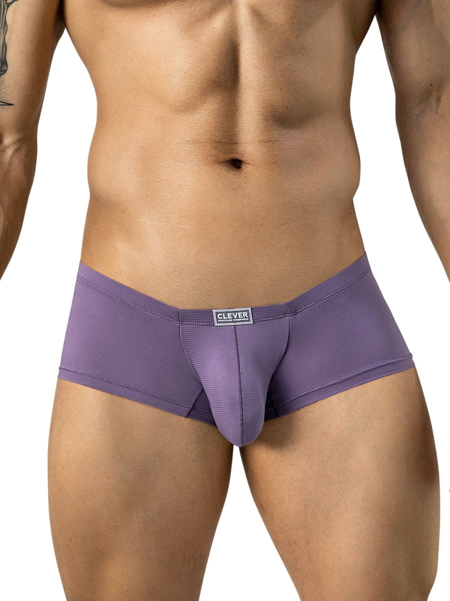 A man models lilac trunks with a textured knit fabric and a small brand logo centered on the waistband.