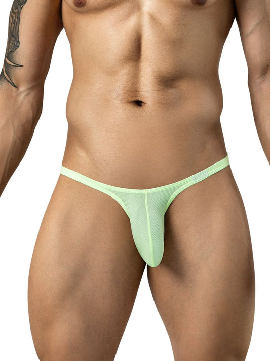 A man models neon green low-rise mesh briefs with a thin waistband on a white background.