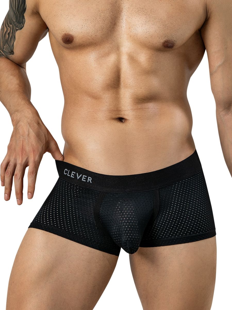 A muscular man wearing black mesh trunks with a branded waistband.