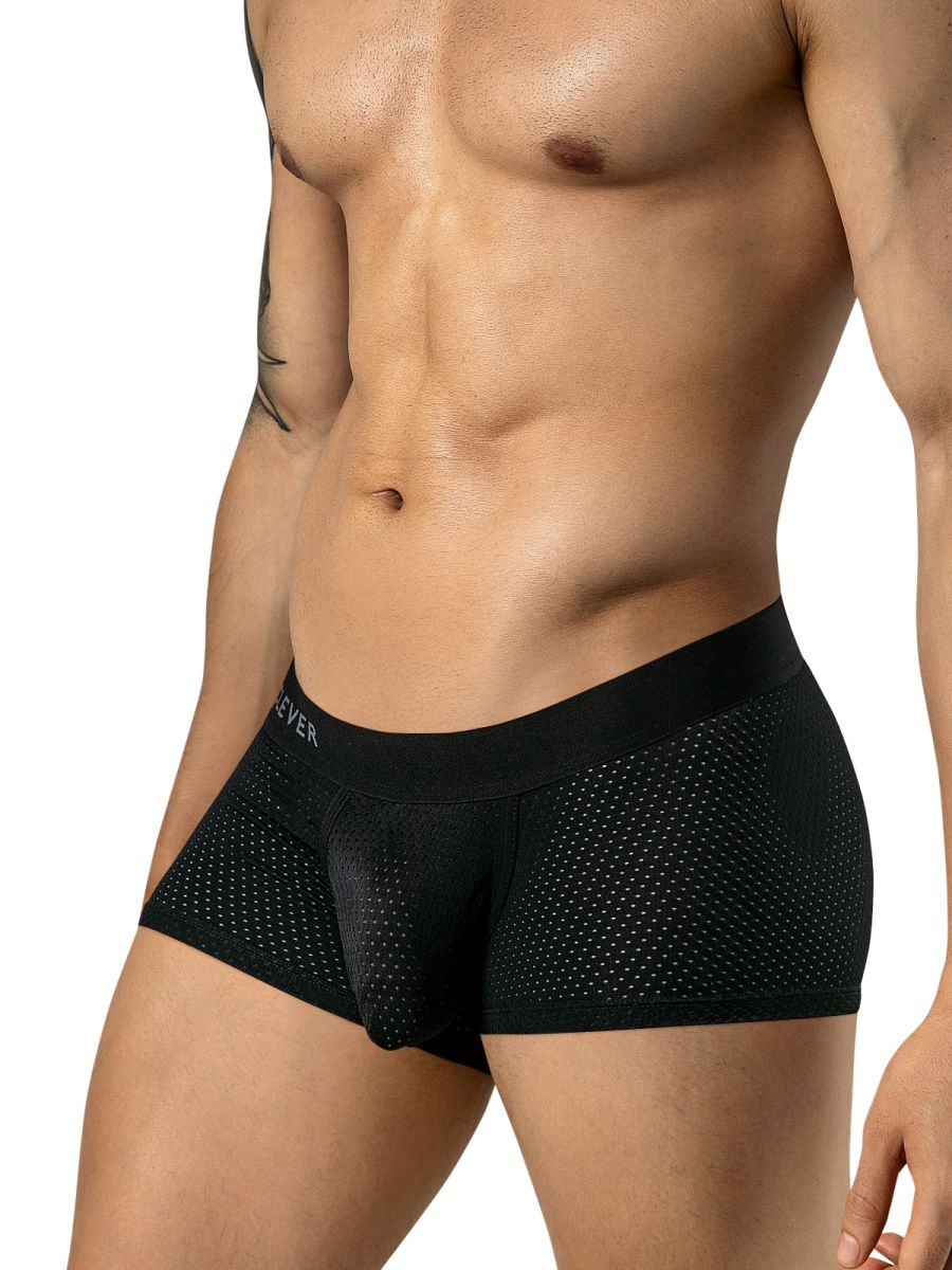 A man wears black mesh trunks with a wide, branded elastic waistband.