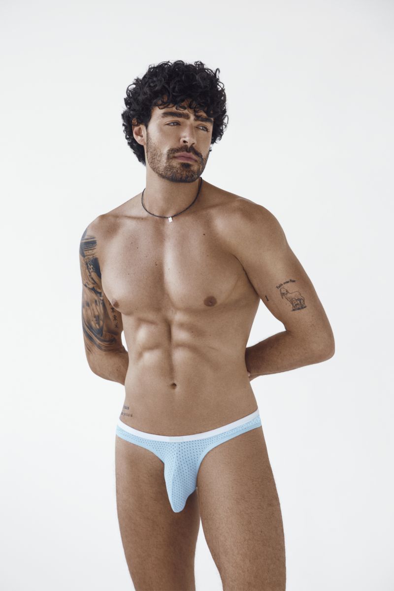 A man models light blue mesh Ulises briefs with a white waistband.