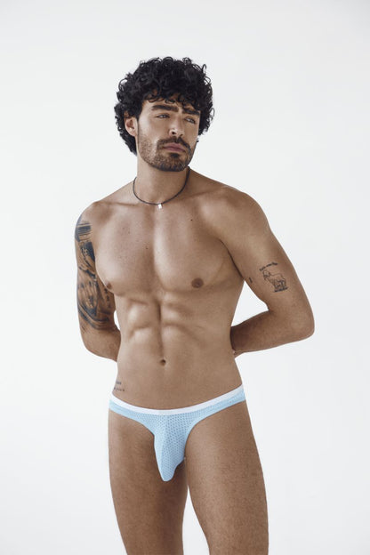 A man models light blue mesh Ulises briefs with a white waistband.