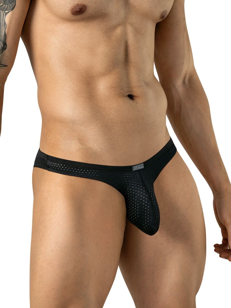 A man wearing black mesh briefs with a small logo tab on the waistband, shown from the front.