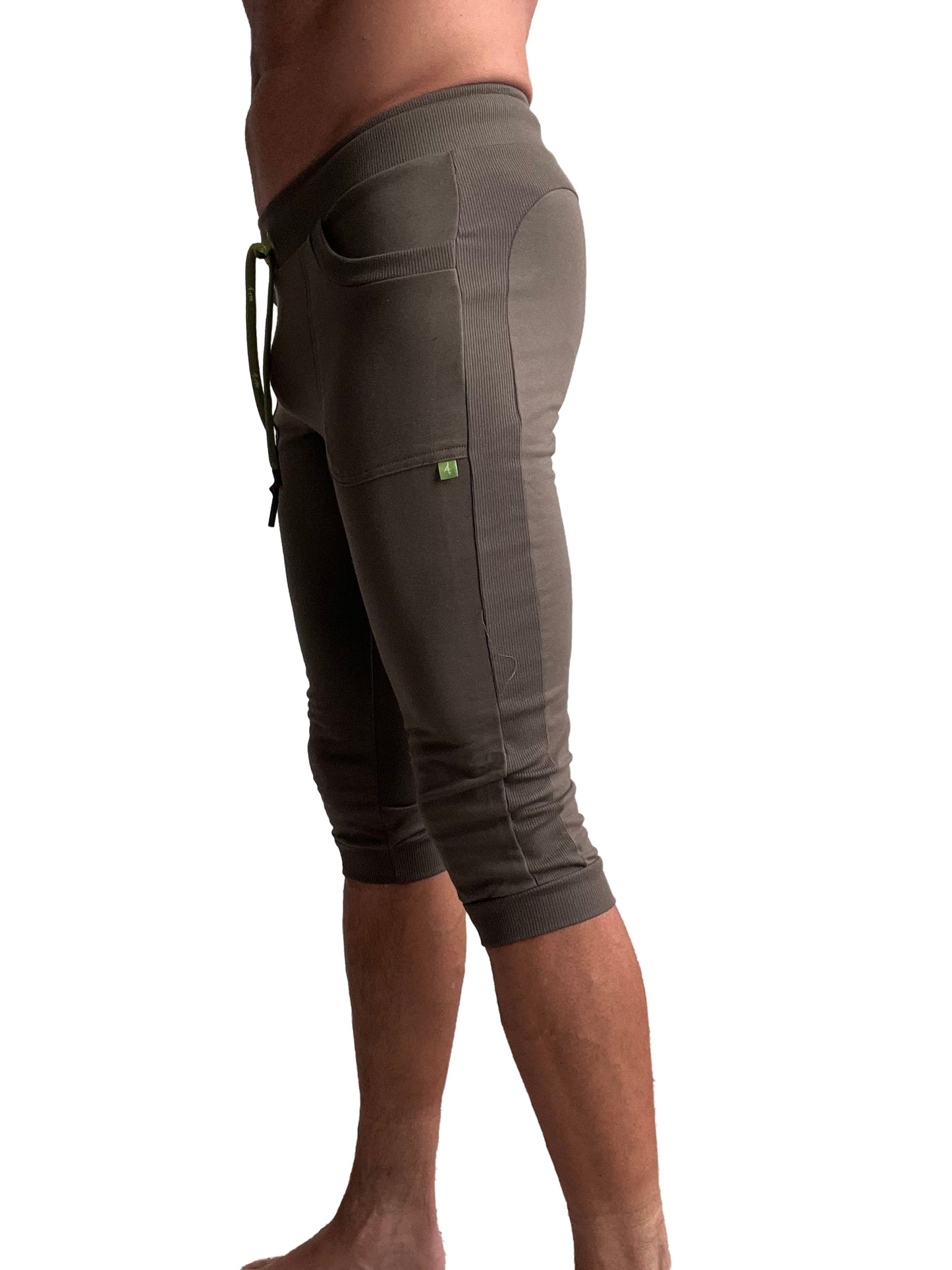 Olive green ribbed knit cuffed yoga pants with side pockets and drawstring waistband for comfortable wear